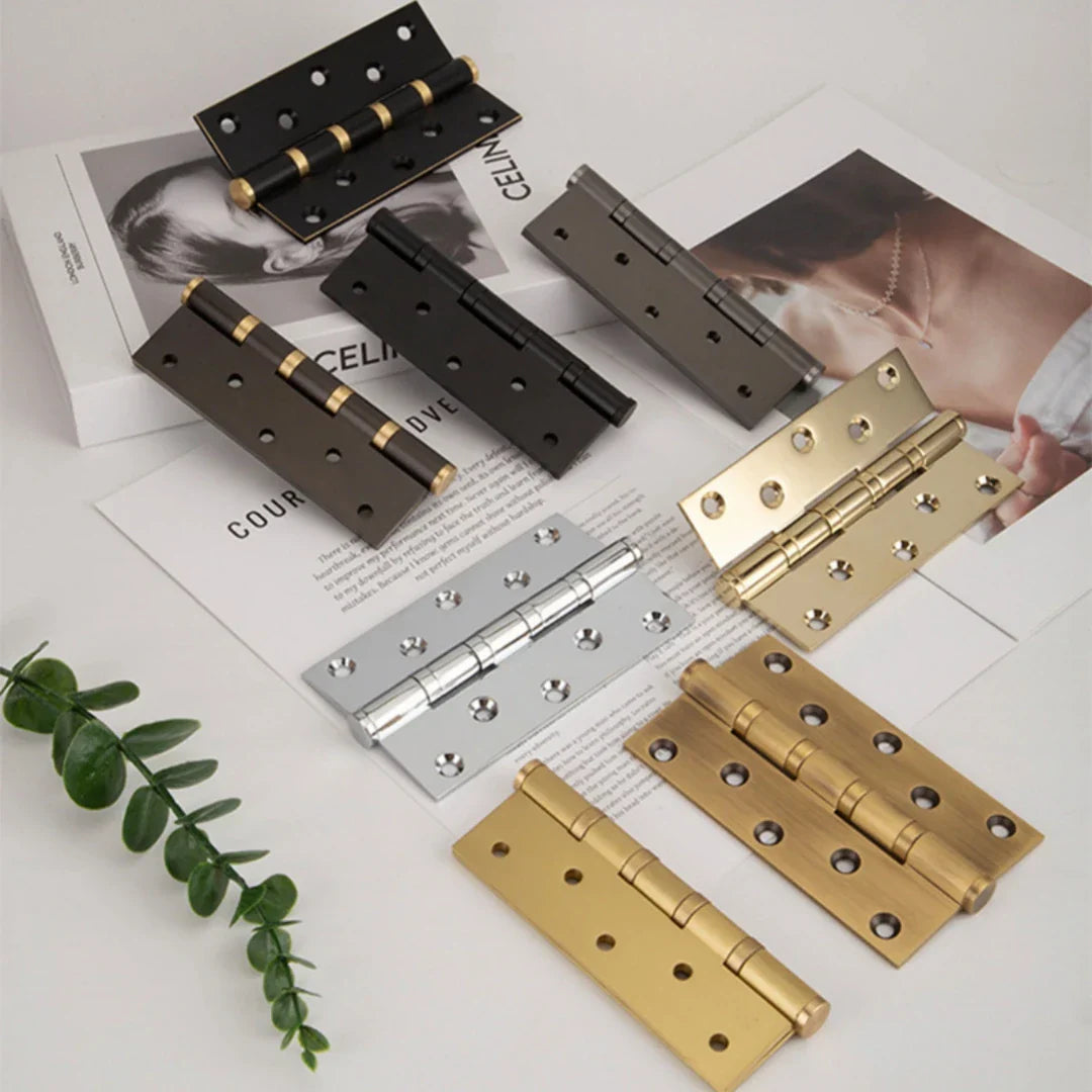 A flatlay of door hinges of different metal finishes.