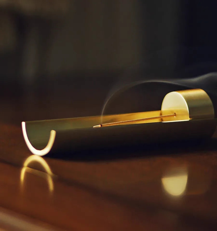Modern incense burner with smoke on a dark background