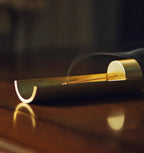 Modern incense burner with smoke on a dark background